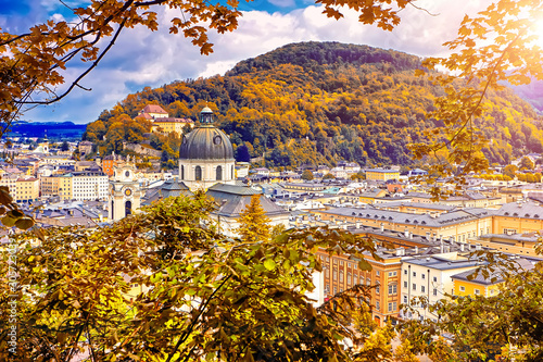 Aerial panoramic view of the historic city of Salzburg with Salzach river in beautiful golden evening light with blue sky and clouds at sunset in summer, Salzburger Land, Austria