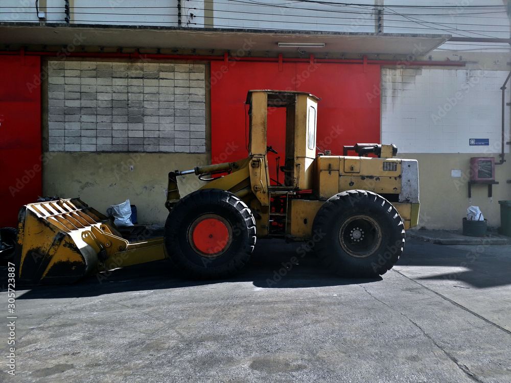 Big yellow car loader in the warehouse.