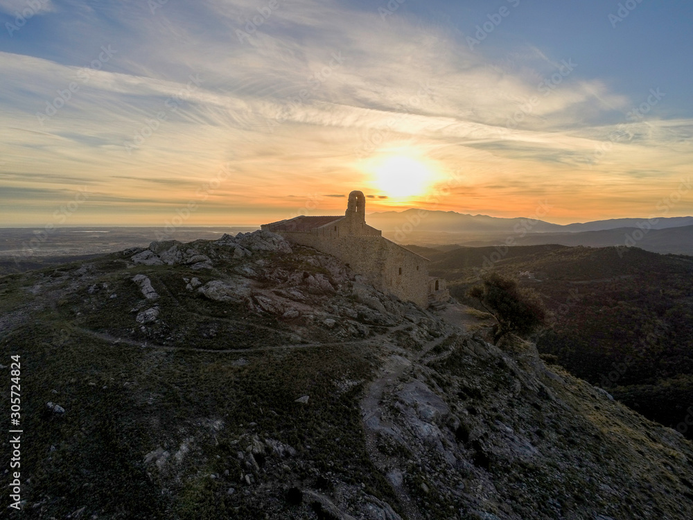 Sant marti Chapel in backlight at sunrise Sant marti Chapel in backlight at sunrise