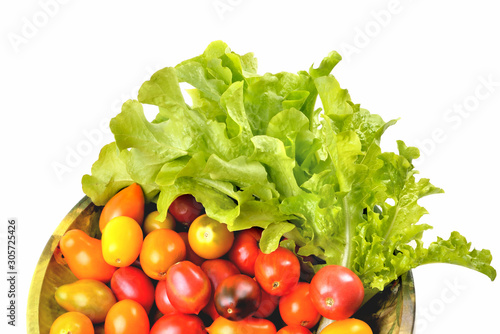 Fototapeta Naklejka Na Ścianę i Meble -  lettuce yellow and red tomatoes, cherry tomatoes on a vintage dish white background, isolate, top view