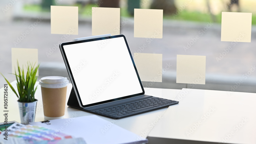Fototapeta premium Mockup tablet on workspace with coffee, colour book.