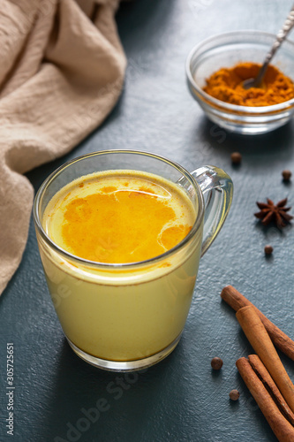 Indian turmeric latte on a blue background