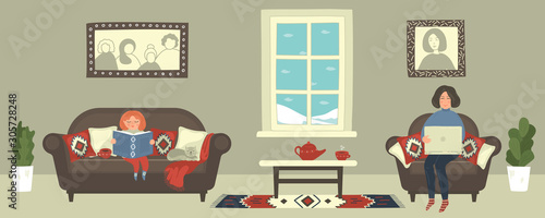 Freelance woman. Modern mother working with laptop at home, while her daughter reading book. Female freelancer sitting in cozy armchair. Multitasking
