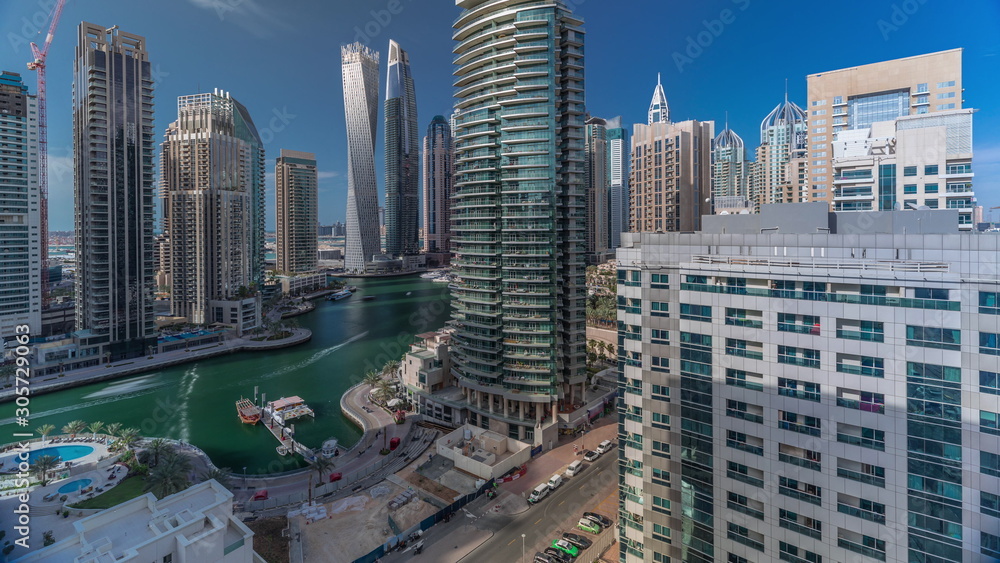 Naklejka premium Aerial view of Dubai Marina residential and office skyscrapers with waterfront timelapse
