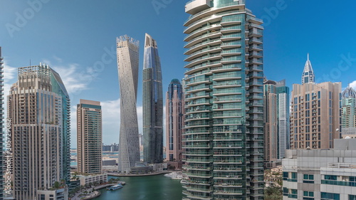 Aerial view of Dubai Marina residential and office skyscrapers with waterfront timelapse