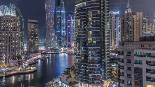 Aerial view of Dubai Marina residential and office skyscrapers with waterfront night timelapse © neiezhmakov