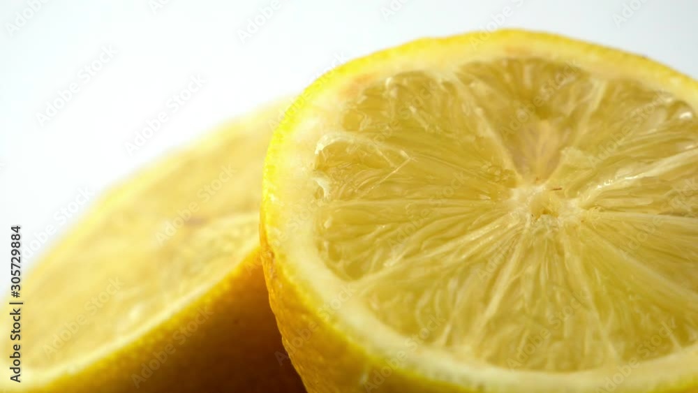Water drops like rain on a portion of sliced lemon, isolated in front of a bright white studio backdrop Water drops like rain on a portion of sliced lemon, isolated in front of a bright white studio backdrop