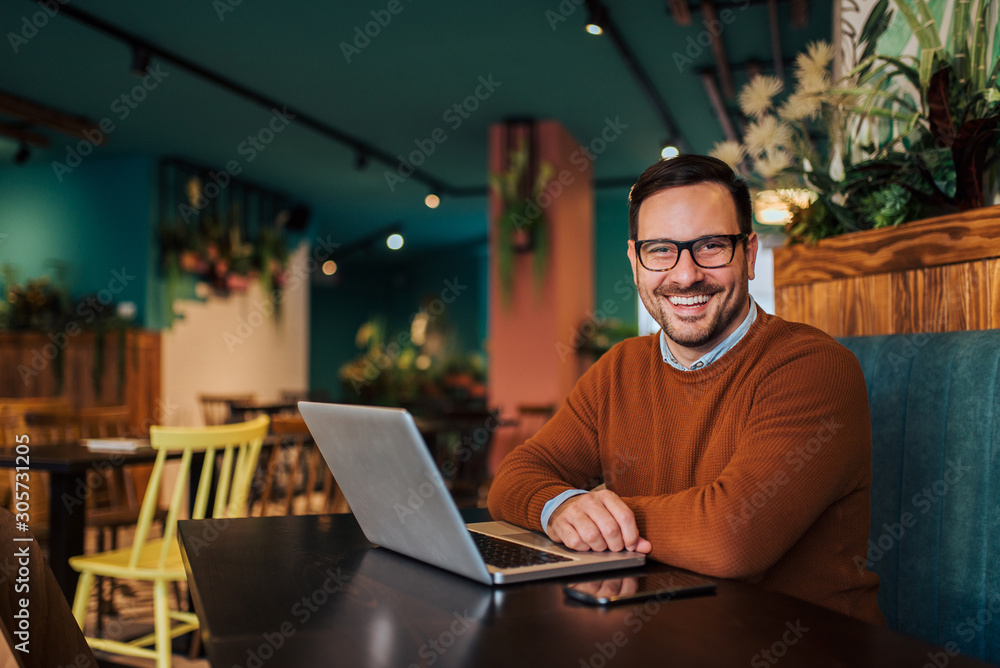 Portrait of a casual businessman in the cafe, smiling at camera. Portrait of a casual businessman in the cafe, smiling at camera.