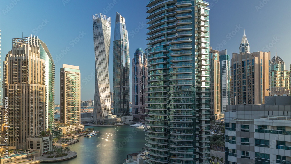 Fototapeta premium Aerial view of Dubai Marina residential and office skyscrapers with waterfront timelapse