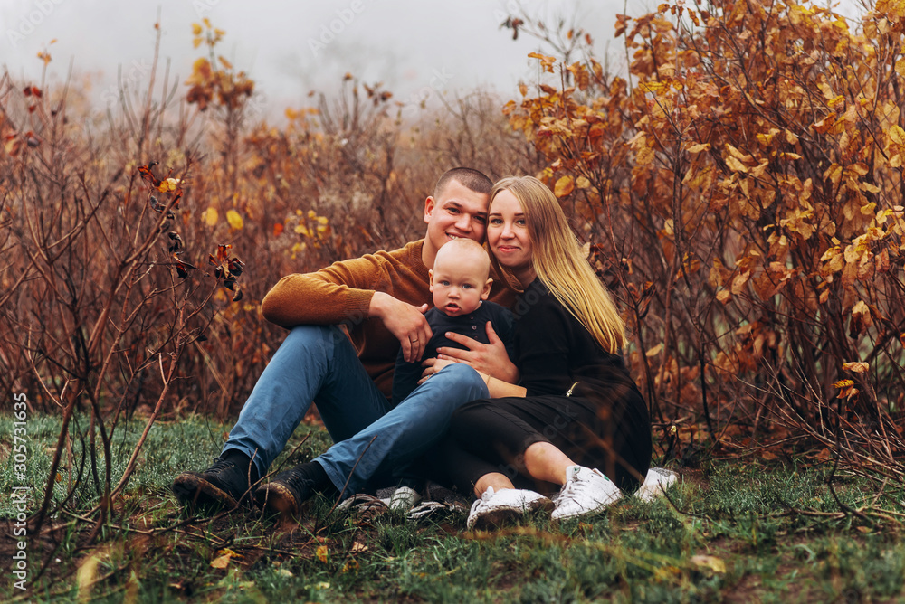 Happy family resting in beautiful autumn park Happy family resting in beautiful autumn park