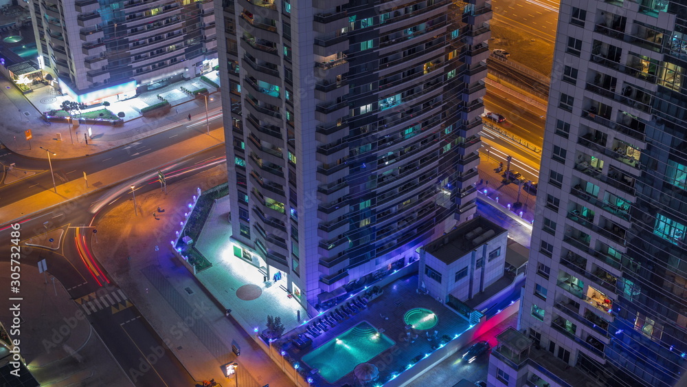 View of various skyscrapers and towers in Dubai Marina from above aerial night timelapse View of various skyscrapers and towers in Dubai Marina from above aerial night timelapse