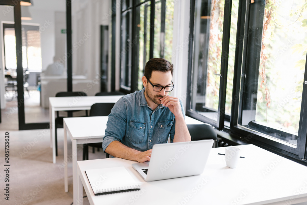 Portrait of a focused handsome man doing research. Portrait of a focused handsome man doing research.