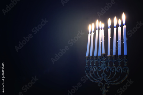 Religion image of jewish holiday Hanukkah background with menorah (traditional candelabra) and candles