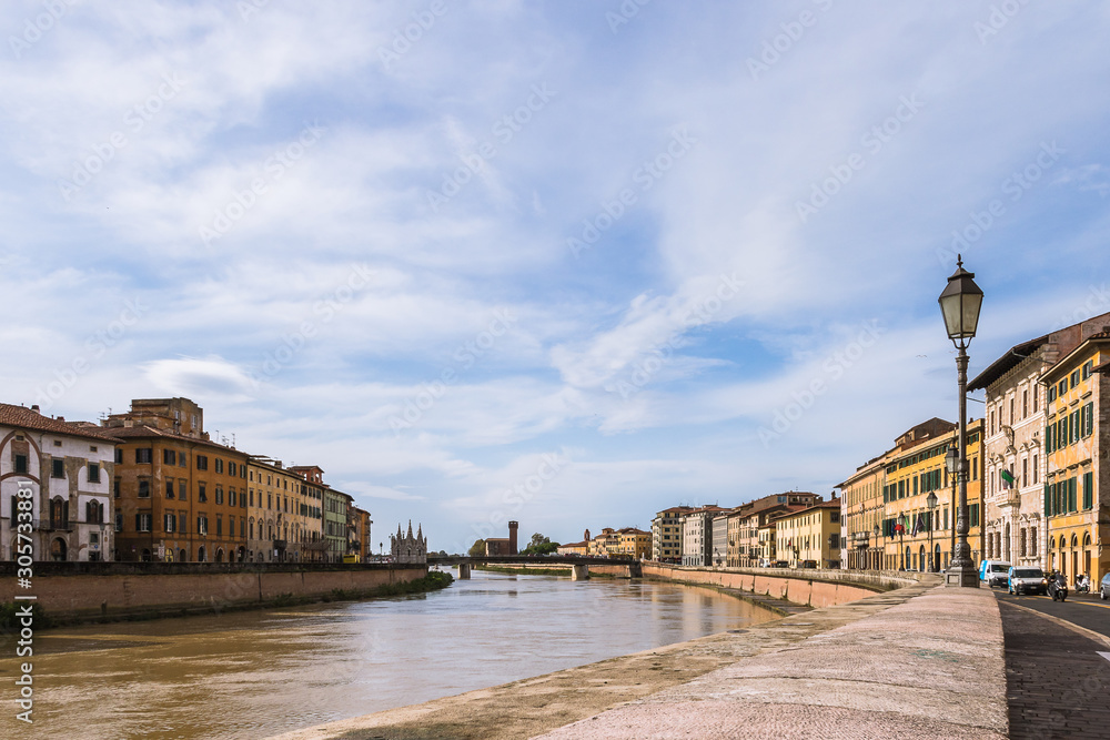 Pisa  urbanscape with Arno River under the blue sky.