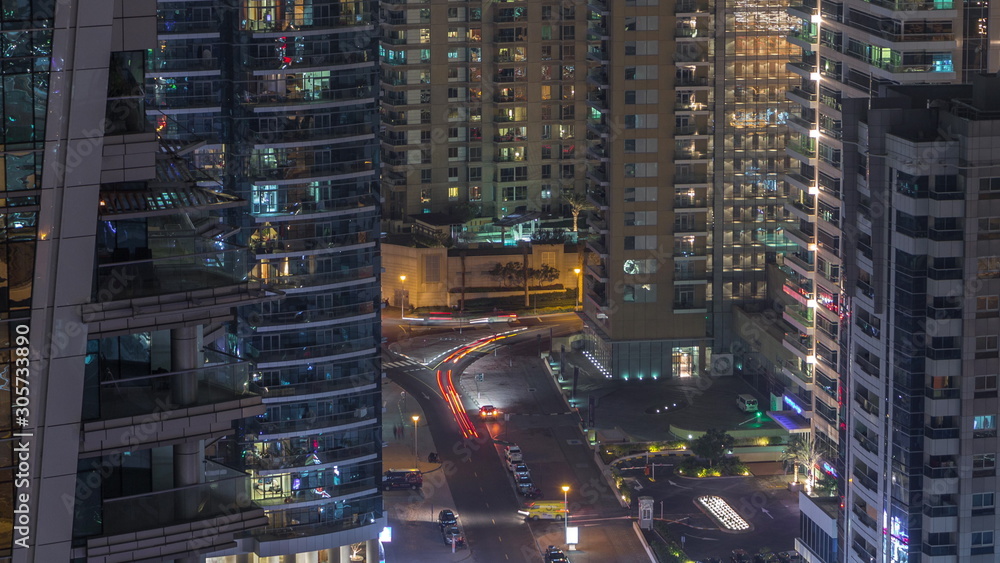 View of various skyscrapers and towers in Dubai Marina from above aerial night timelapse View of various skyscrapers and towers in Dubai Marina from above aerial night timelapse