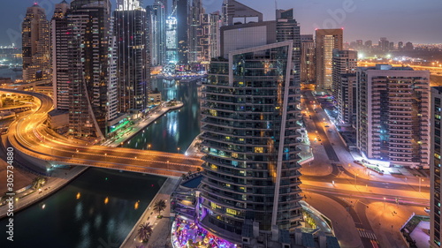Aerial view of Dubai Marina residential and office skyscrapers with waterfront night to day timelapse © neiezhmakov