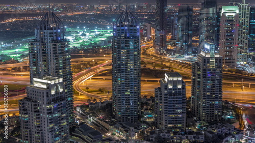 Dubai Marina skyscrapers and jumeirah lake towers view from the top aerial night timelapse in the United Arab Emirates.