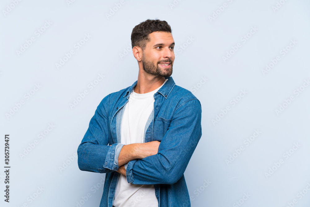 Handsome man over isolated blue background with arms crossed and happy Handsome man over isolated blue background with arms crossed and happy