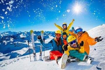Happy family enjoying winter vacations in mountains. Playing with snow, Sun in high mountains. Winter holidays.