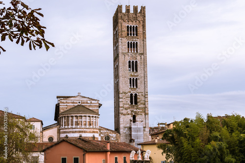 City scape of Lucca with the bell tower of the cathedral, the small medieval town in Tuscany Italy among trees.