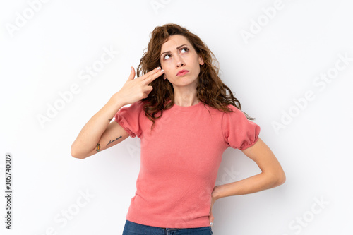 Young pretty woman over isolated background with problems making suicide gesture