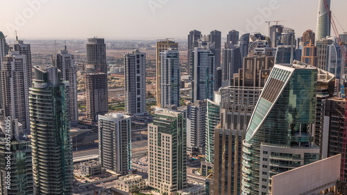Dubai Marina skyscrapers and jumeirah lake towers sunrise view from the top aerial timelapse in the United Arab Emirates. © neiezhmakov