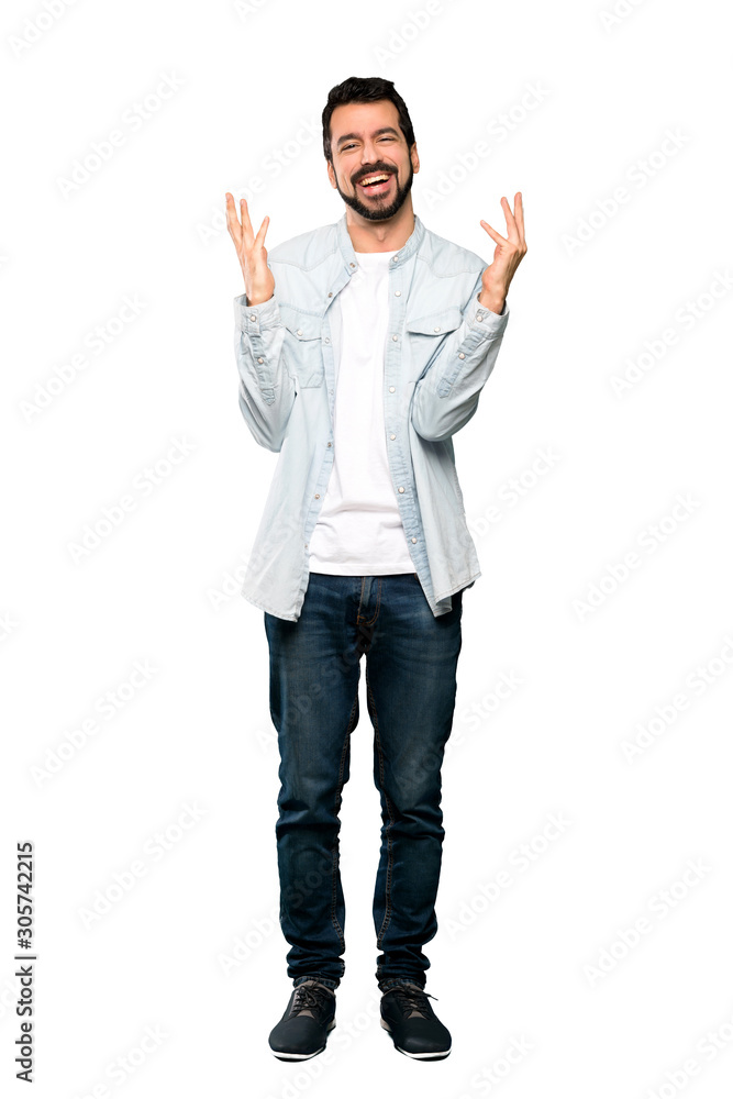 Full-length shot of Handsome man with beard smiling a lot over isolated white background Full-length shot of Handsome man with beard smiling a lot over isolated white background