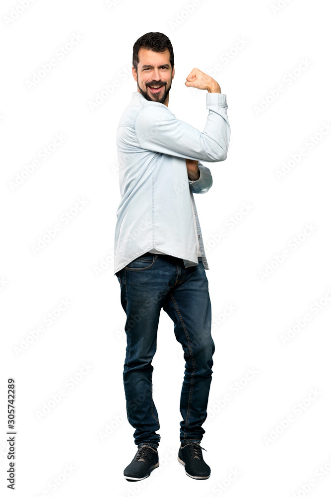 Full-length shot of Handsome man with beard doing strong gesture over isolated white background Full-length shot of Handsome man with beard doing strong gesture over isolated white background