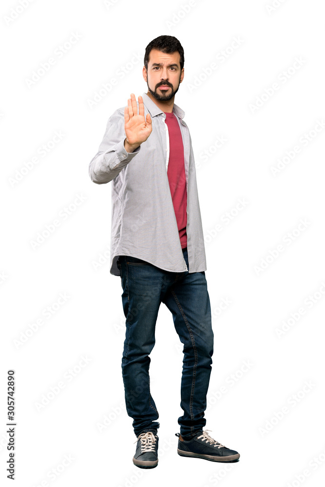 Full-length shot of Handsome man with beard making stop gesture over isolated white background Full-length shot of Handsome man with beard making stop gesture over isolated white background