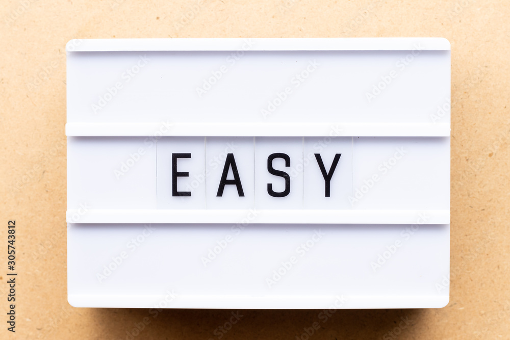 Lightbox with word easy on wood background Lightbox with word easy on wood background