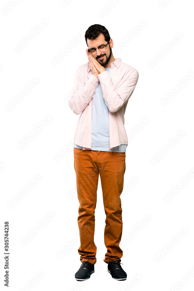 Full-length shot of Handsome man with beard making sleep gesture in dorable expression over isolated white background Full-length shot of Handsome man with beard making sleep gesture in dorable expression over isolated white background