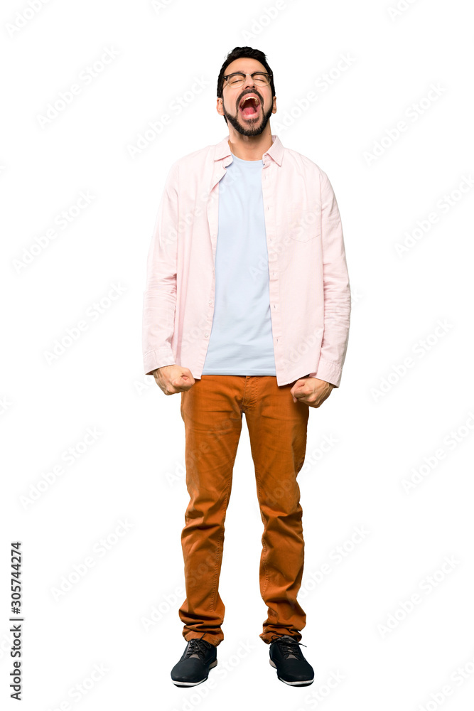 Full-length shot of Handsome man with beard shouting to the front with mouth wide open over isolated white background Full-length shot of Handsome man with beard shouting to the front with mouth wide open over isolated white background