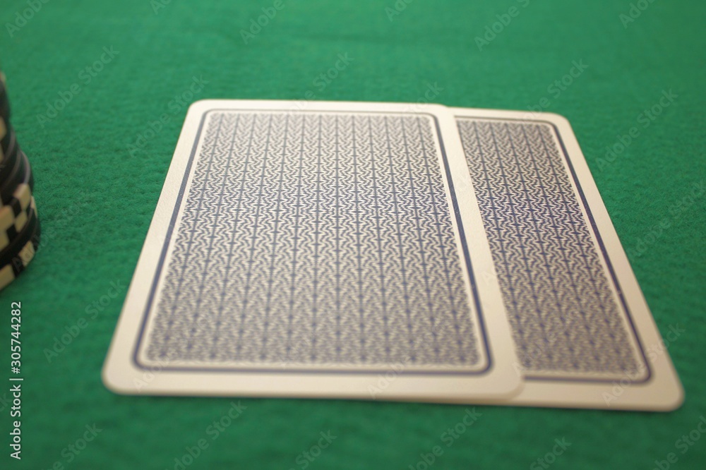 Face down cards on a green table