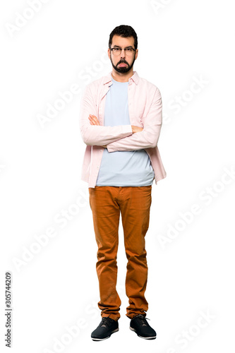 Full-length shot of Handsome man with beard with sad and depressed expression over isolated white background