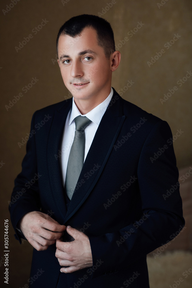 Morning groom. Fees groom in the room. Wedding photography. Portrait of a young man. Morning groom. Groom getting ready in the room for wed day. Morning groom. Fees groom in the room. Wedding photography. Portrait of a young man. Morning groom. Groom getting ready in the room for wed day.