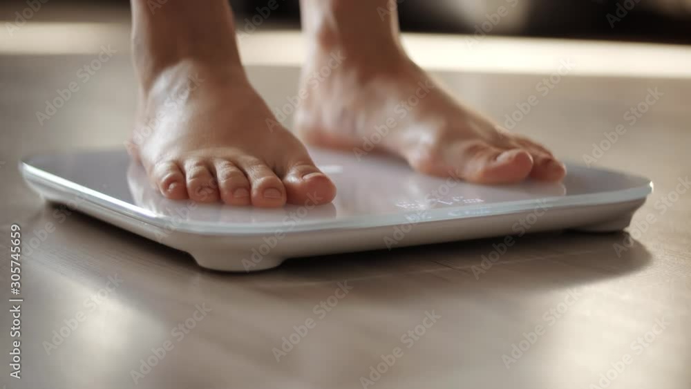 Woman On Scales Measure Weight.Girl Legs On Bathroom Scale.Weighing