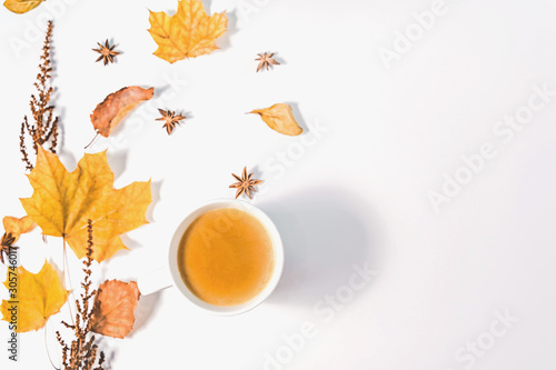 Autumn or Winter composition with dried autumn leaves  coffee cup pine and and anise stars. Flat lay  top view.