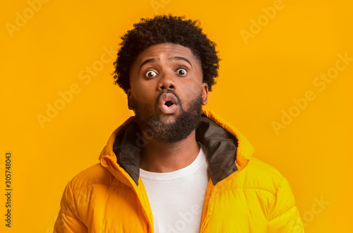 Emotional surprised bearded winter man standing with open mouth