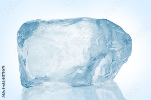 Chrystal clear frosted natural ice block in cold light blue tones on reflective surface. Clipping path included.