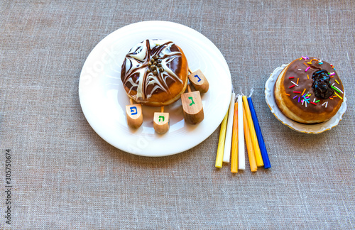 Festive donuts and candles are traditional symbols of Hanukkah Holiday
