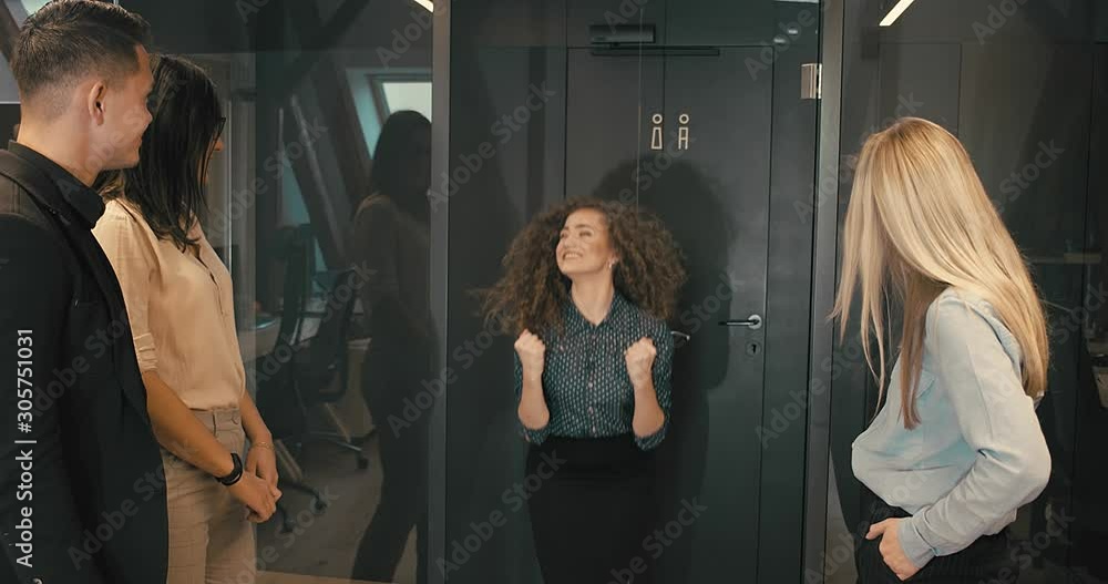 4K slow motion. Funny of young business people. Mixed race creative team meeting in modern work space. We are stronger together. 4K slow motion. Funny of young business people. Mixed race creative team meeting in modern work space. We are stronger together.