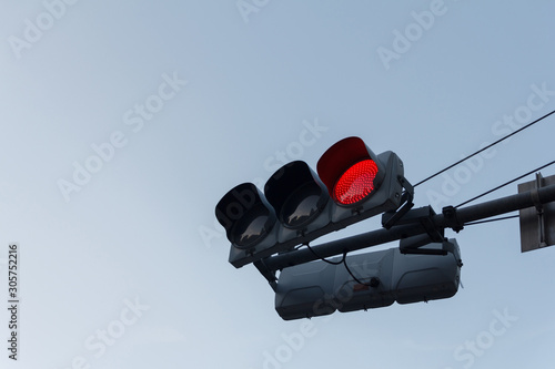 Red traffic light ,isolated on sky background