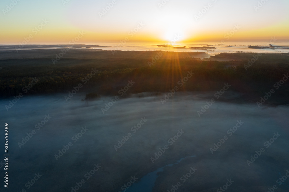 Fototapeta premium Sunny and foggy morning over the river, fog in the sun.
