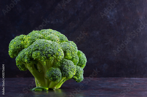 Broccoli on a dark background. Fresh broccoli with copy space. Healthy green food clean eating. Vegetarian food. Minimalism