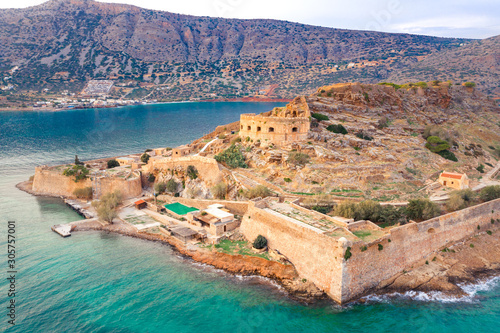 View of the island of Spinalonga with calm sea. Here were isolated lepers, humans with the Hansen's desease, gulf of Elounda, Crete, Greece.  photo