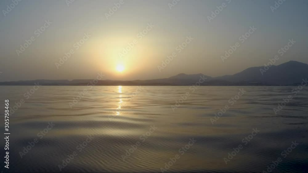 Cruising towards land at sunset on the ocean. Cruising towards land at sunset on the ocean.
