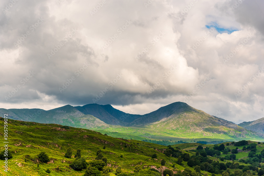 Rainclouds gather, cast shadows over the southern fells of the English Lake District. Rainclouds gather, cast shadows over the southern fells of the English Lake District.