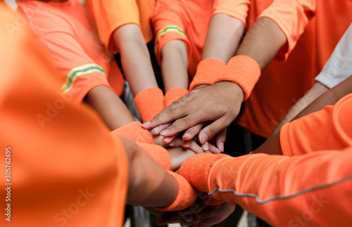 sport player use hand holding hand of friend together, they feeling strong teamwork and unity, spirit in games 
