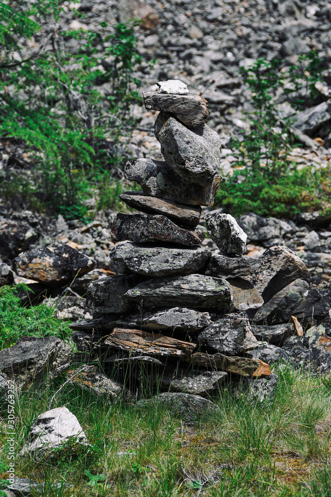 Slide of stones for orientation in forest. Hiking in mountains. Meditation, state of balance of  soul. Yoga classes in nature