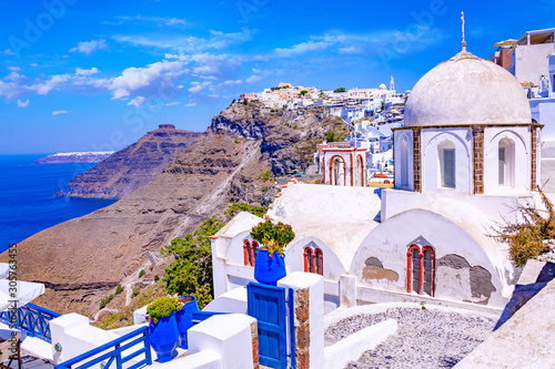 Beautiful Thira town on Santorini island, Greece. Traditional white houses and churches over the Caldera in Aegean sea